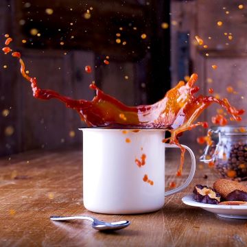 Coffee splashing in mug